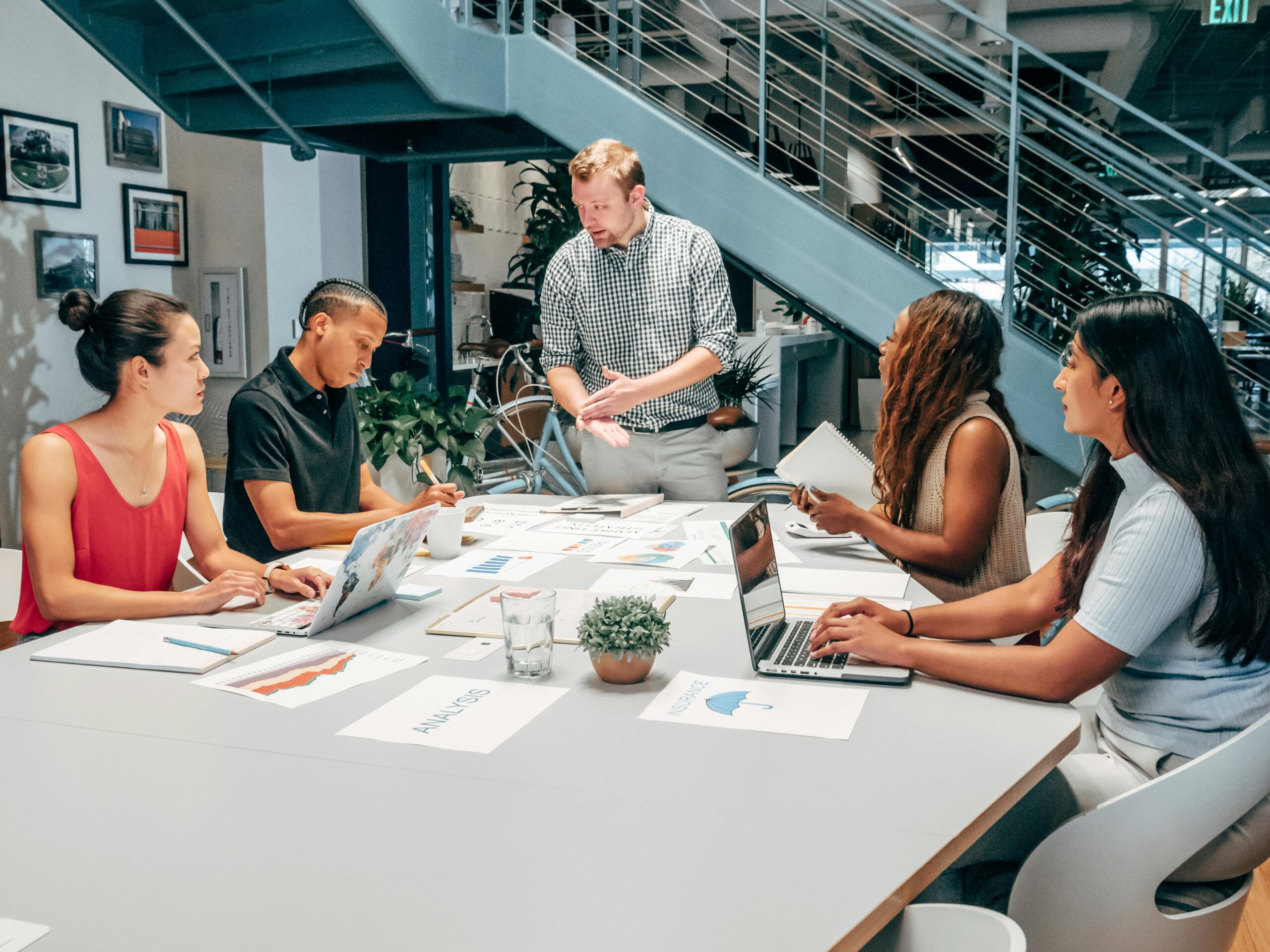 Professionals having a meeting on their sales prospecting techniques.